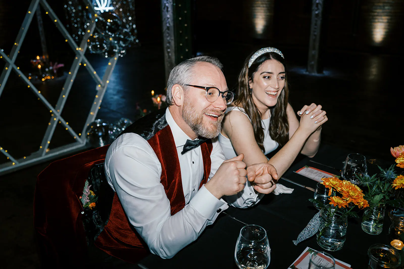 Emma and Rich smiling together at their wedding